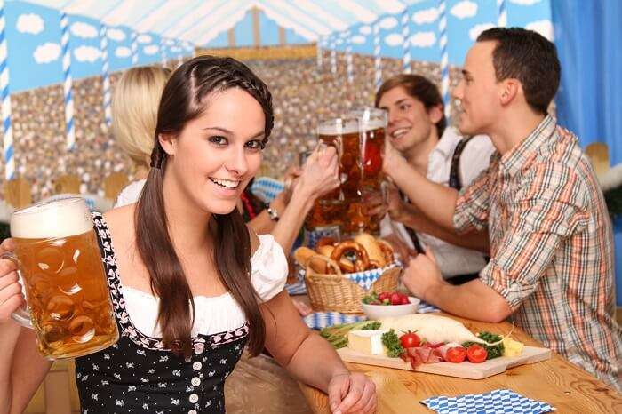 girl drinking beer at Oktoberfest in Germany