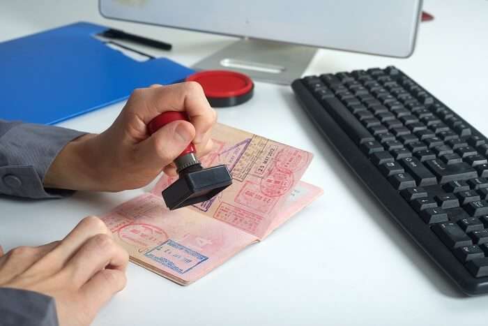 Immigration officer stamping the VISA-on-arrival on the passport