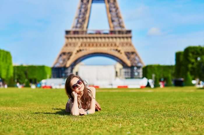 a girl posing near Eiffel Tower Paris