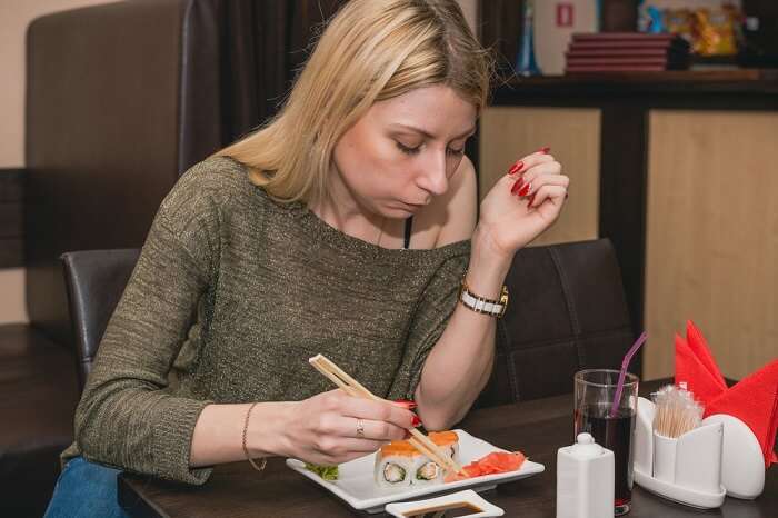 girl eating sushi in Japan