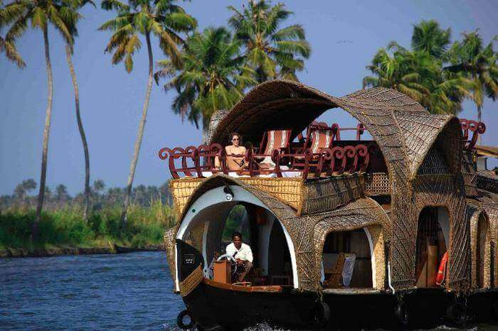 houseboat in Kerala with palm trees in the background