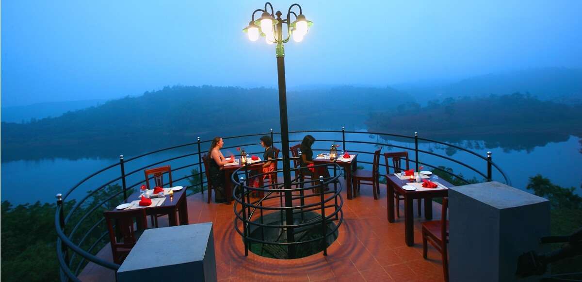 Guests enjoying food at the open air seating area of Sharoy Resorts