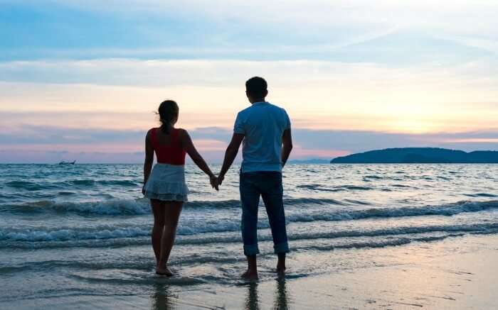 Sunset and couple on a beach in Thailand