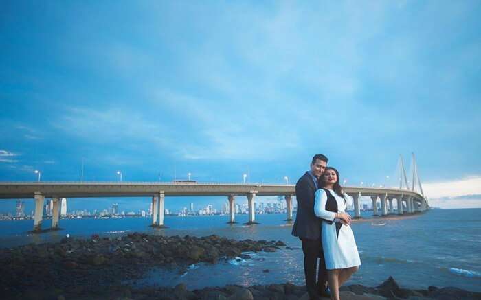 Shot of a couple in front of Sea Link in Band Stand Bandra