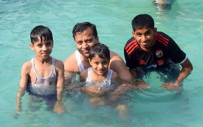 Family enjoying at the pool in jim corbett