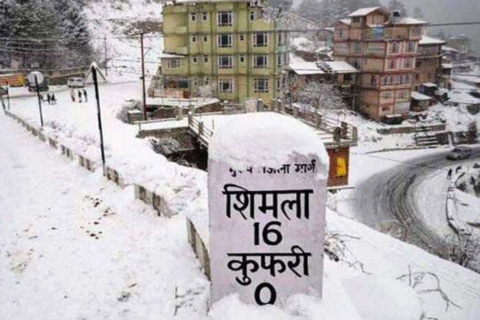 Milestone in Shimla covered in snow by the road