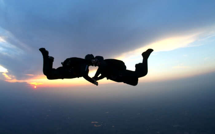 A couple kissing while skydiving