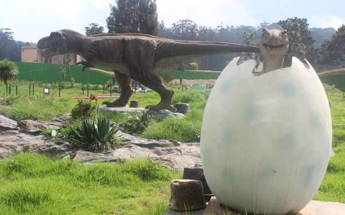 dinosaur egg and statue in an amusement park in Ooty