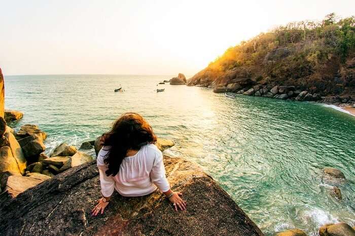 A traveler enjoying a sunset at the Butterfly beach in Goa