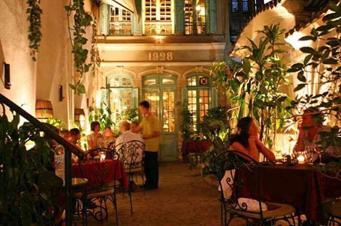 -People having dinner at the romantic Green Tangerine restaurant in Hanoi