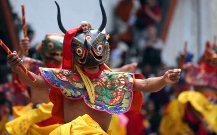 man wearing mask and performing during Sikkim summer festival