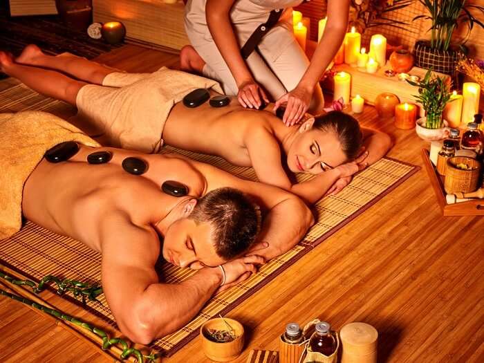 A couple luxuriates in bamboo spa