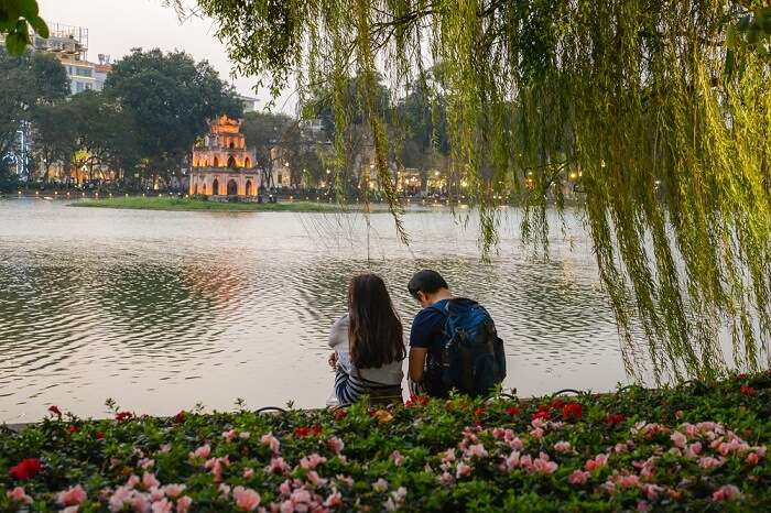 shutterstock_598382717-kw-200417-A couple looking at Turtle tower in the center of Hoan kiem lake at sunset