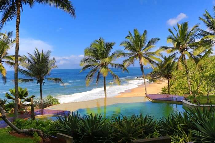 A shot of the swimming pool by the sea at Niraamaya Retreat in Kovalam