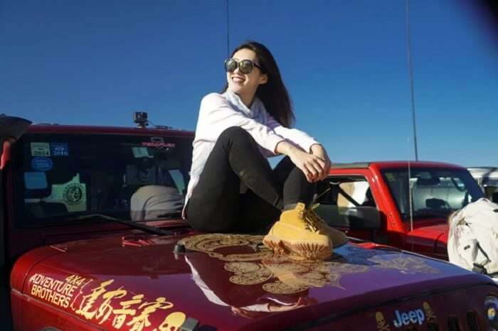 woman on car in ulan buh desert