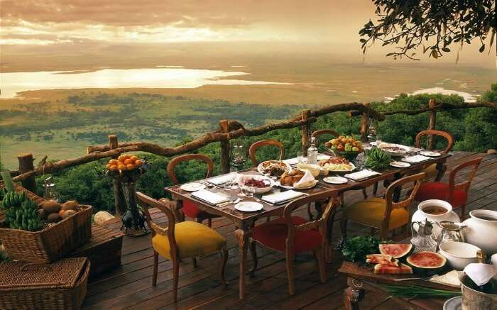 A lavish meal set in the open at a safari honeymoon lodge in Africa