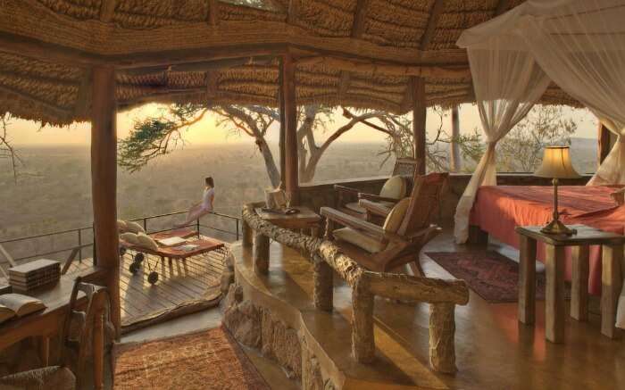 A woman enjoying nature view from a safari honeymoon resort 