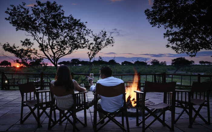 Couple enjoying a romantic evening outside Belmond Savute Elephant Camp in Botswana 