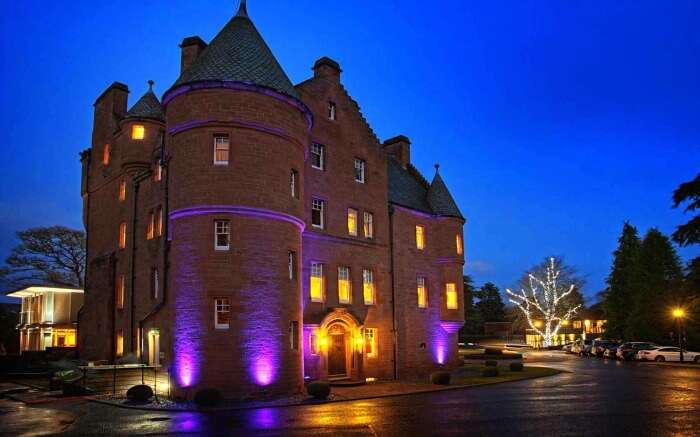 Fonab Castle lit up in evening 