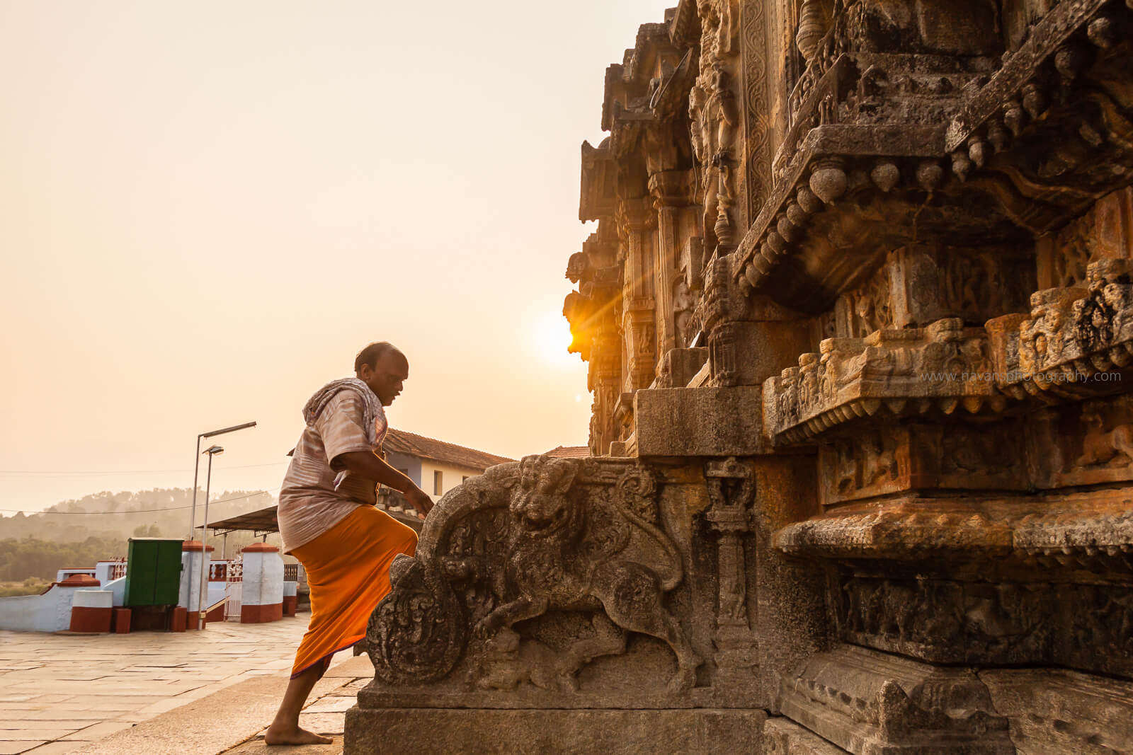 An old man climbing the stairs of Gopalakrishna Temple