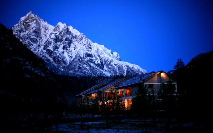 Night view of Banjara Retreat in Sangla overlooking snow clad peaks