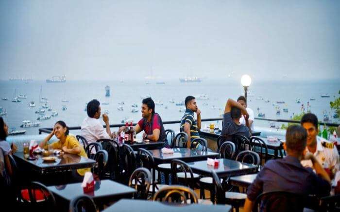 People having food at the rooftop dining space of Bayview cafe in Mumbai 