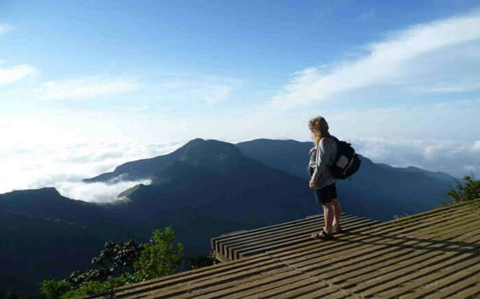 Traveler standing on a raised platform overlooking Horton Plains National Park in Kandy