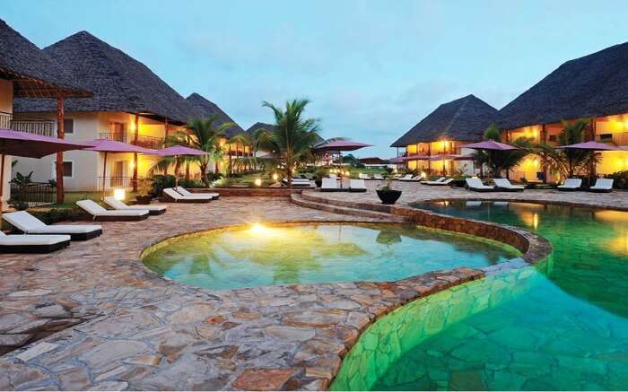 a Zanzibari thatched roof villas in a resort 