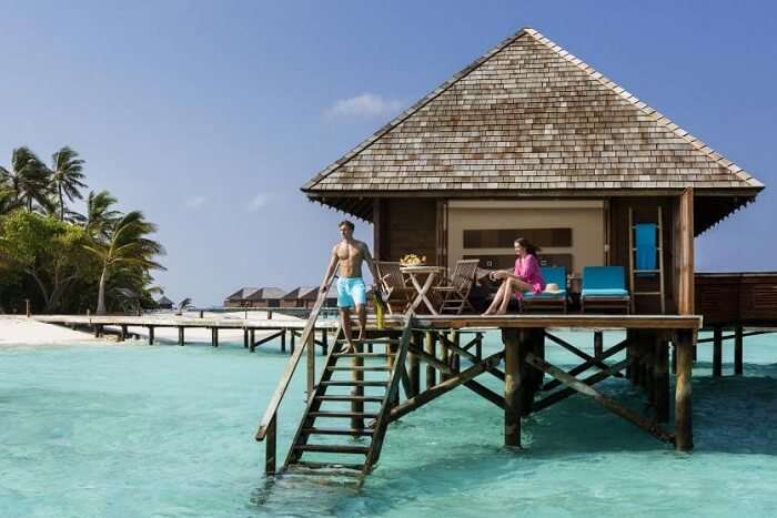 A couple staying at an overwater villa at the Veligandu Island Resort in Maldives