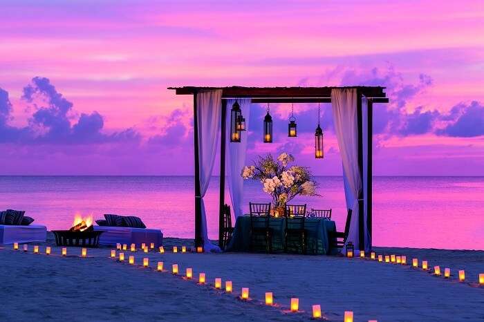 A candle-lit dining option at the Ritz Carlton beach with a draped gazebo for an intimate dinner on a honeymoon in Cayman Islands