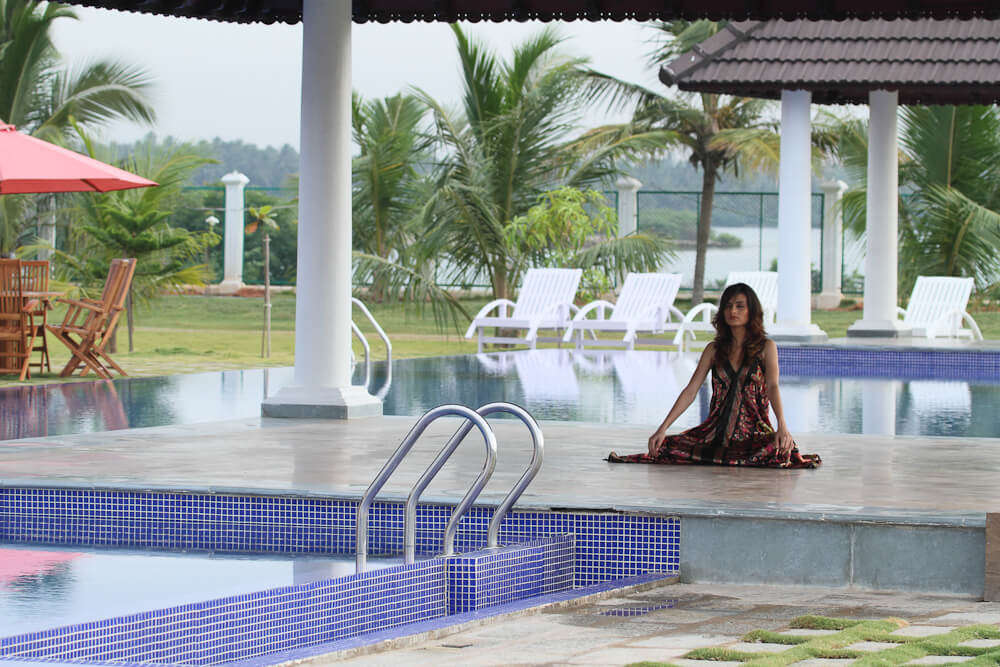 a lady meditating in front of a pool in Le Pondy