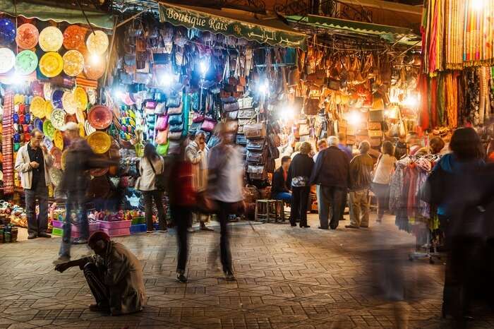A couple walking through the night markets of Marrakech in Morocco