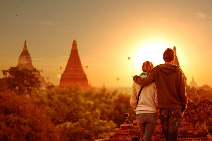 Young couple enjoying the sunset view at Bagan in Myanmar