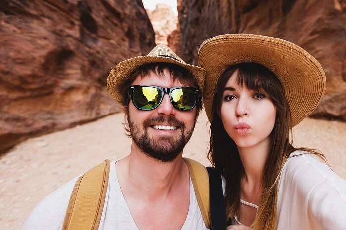 Young couple taking selfie at the canyon on their honeymoon in Jordan
