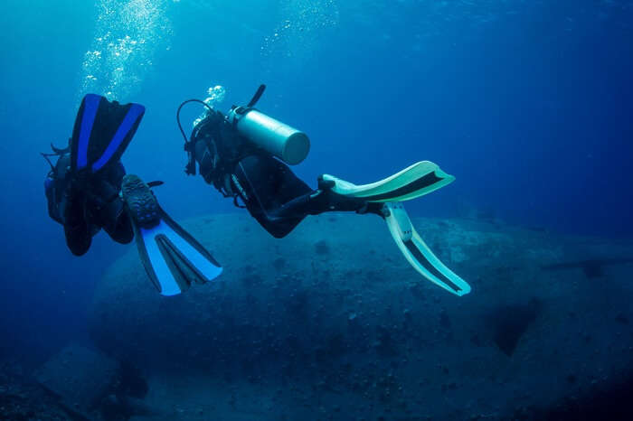 A couple exploring the shipwreck site at Aqaba in Jordan