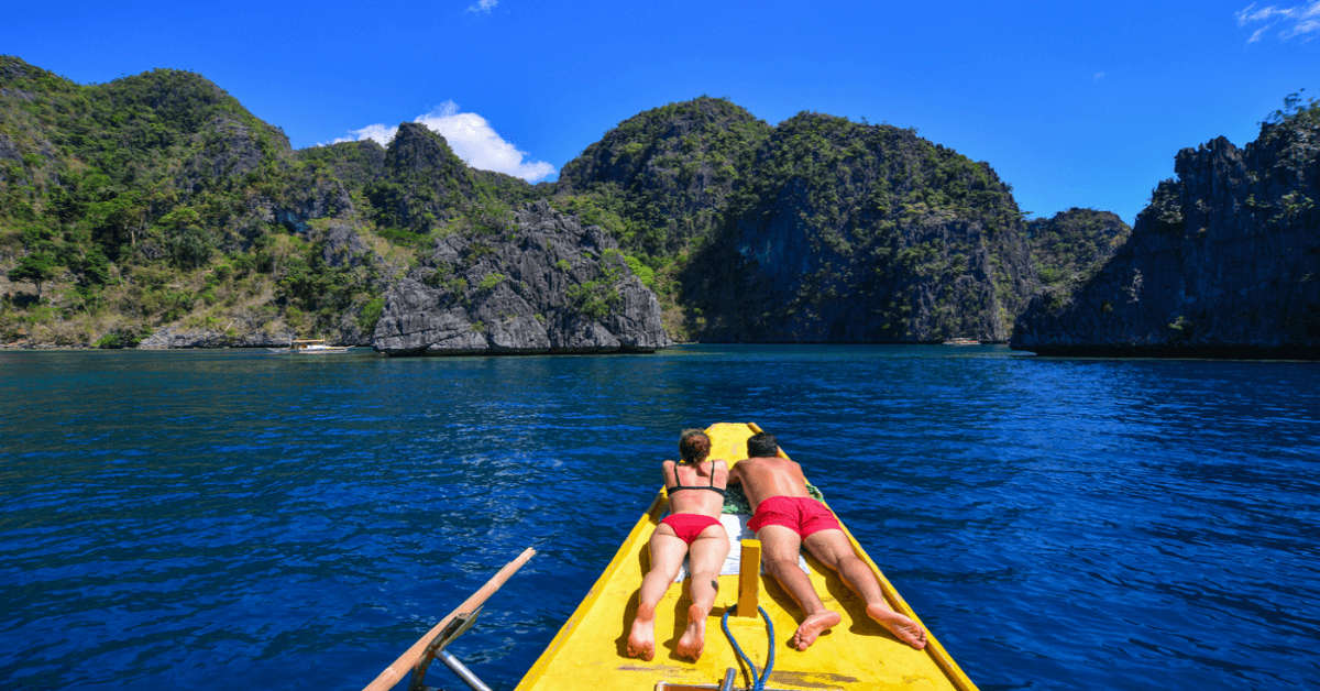 A couple enjoying a boat ride on their Philippines honeymoon