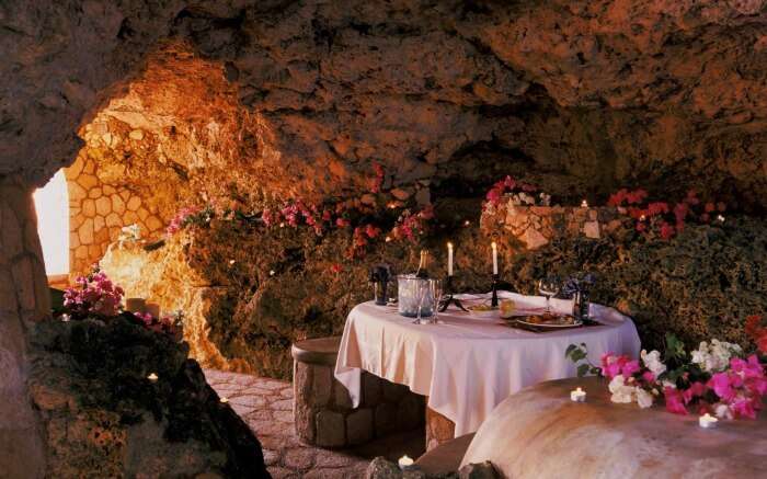 A romantic dinner table in a resort built inside a cave in Jamaica