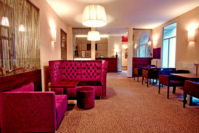 Pink furniture with decorative lighting in a hotel room in Austria