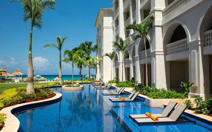 Outdoor swimming pool with sundecks in a resort in Jamaica 