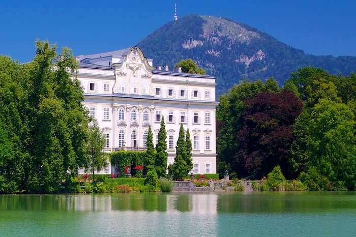 A beautiful hotel by a lake with mountain background