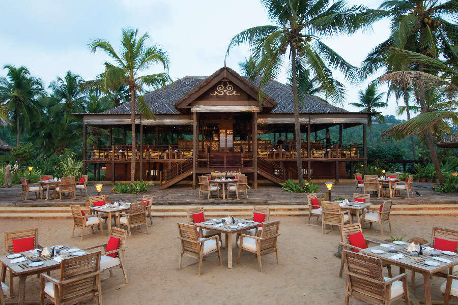 Tables and chairs in the open restaurant of a hotel