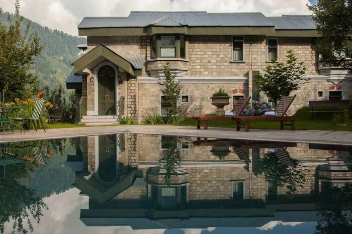 Pool in front of a cottage at the Himalayan Spa Resort