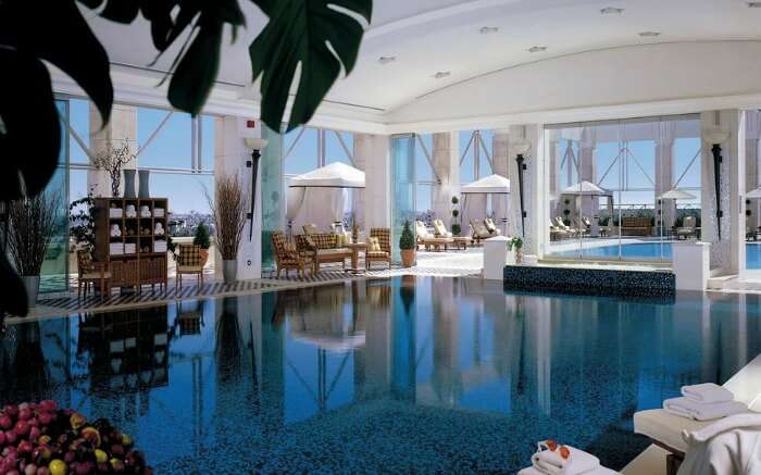 an indoor pool with personal cabanas in a hotel