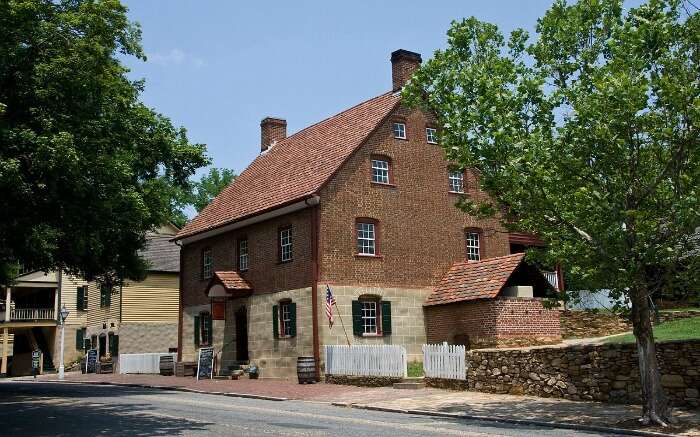 an old house and trees in a small town 