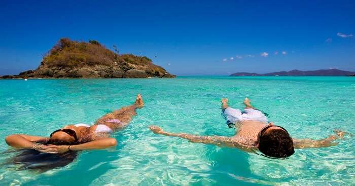 A couple swimming in the Caribbean waters at Trunk Bay in US Virgin Islands