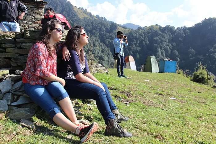 A group of travelers resting at the take off site of paragliding in Bir Billing