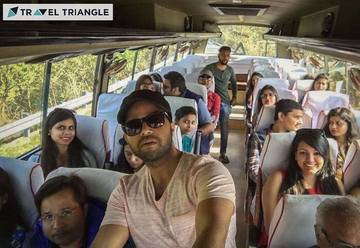 A group of travelers pose for a selfie in the bus taking them on their weekend trip from Delhi to Jim Corbett