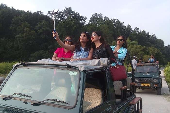 Girls taking selfie during a jeep safari in Jim Corbett
