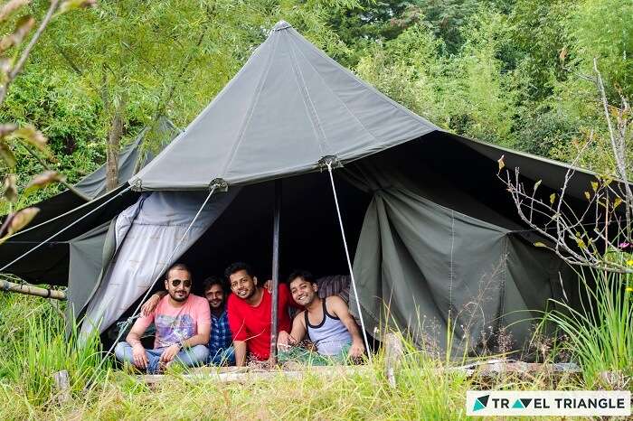 A group posing from the tent at the campsite of Mukteshwar