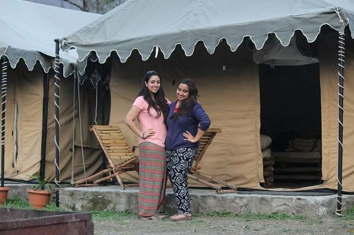 Girls pose for a photograph outside the tents in Rishikesh